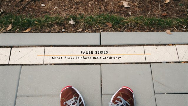 Footwear on Urban Path with Pause Sign Featuring Short Breaks for Habit Consistency in a Relaxed Outdoor Setting