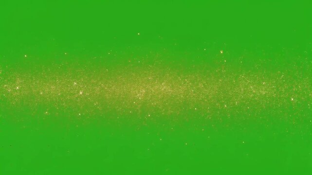 Golden glitter particles shimmering on green screen background gold shimmer