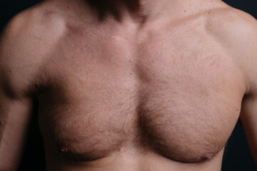 Naklejka premium an athletic-built mature man with a defined abdominal area and large muscles after a grueling workout and a visit to the tanning salon. body parts: firm breasts and elastic muscles. bodybuilding poses