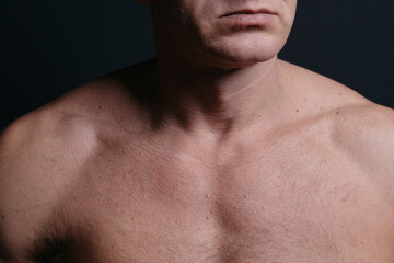 Naklejka premium an athletic-built mature man with a defined abdominal area and large muscles after a grueling workout and a visit to the tanning salon. body parts: firm breasts and elastic muscles. bodybuilding poses