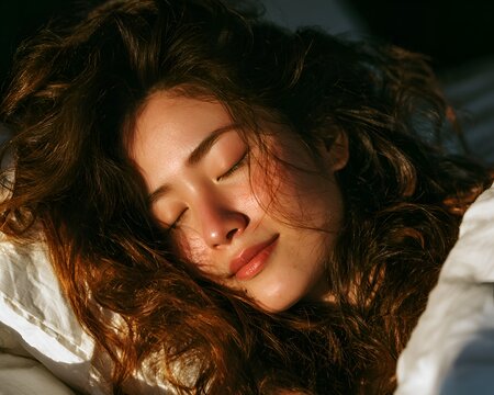 Peaceful young woman sleeping soundly in warm golden light