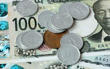 Japanese yen money bills and coins on table. Japan cash of JPY currency close up © Larysa
