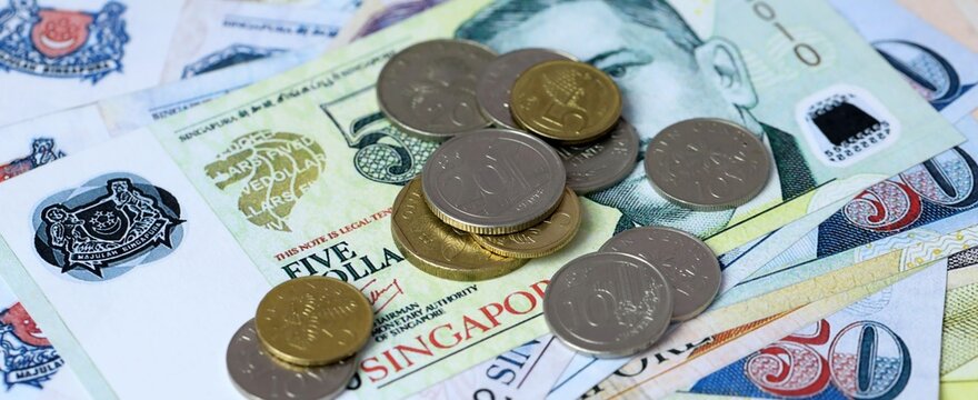 Singapore dollar money bills and coins on table. Singapore cash of SGD currency close up