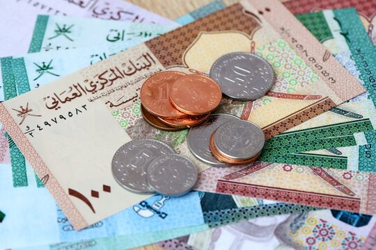 Omani rial money bills and coins on table. Oman cash of OMR currency close up