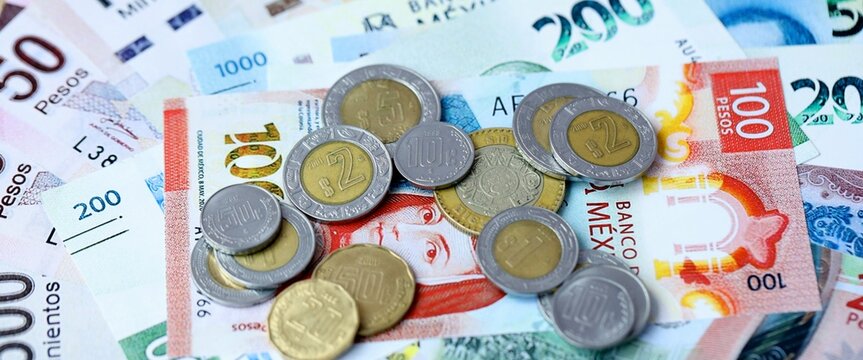 Mexican peso money bills and coins on table. Mexico cash of MXN currency close up