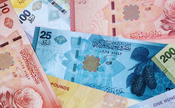 Syrian pound money banknotes bunch on table. Syria bills of SYP currency close up