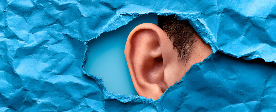 The human ear is depicted within a torn sheet of blue paper. This concept symbolizes eavesdropping or communication barriers. It focuses on hearing and awareness. It also hints at curiosity and the un