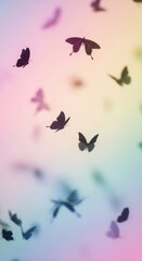 Butterflies flying in colorful sky.