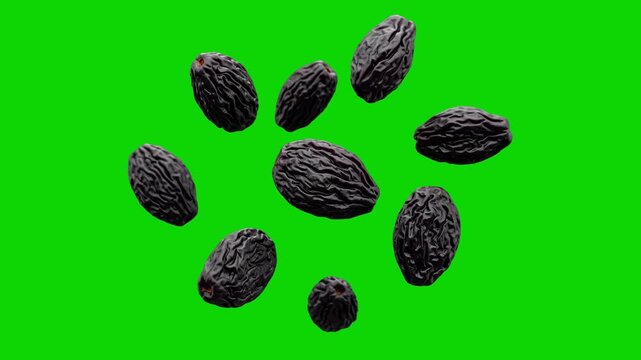 Multiple dried black raisins or prunes suspended and tumbling mid-air against a solid green screen. This chroma key asset is designed for healthy snack marketing, baking tutorials, and grocery ads.