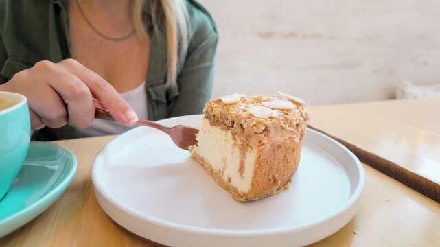Woman eating cheesecake and coffee at cafe shop - Dessert concept