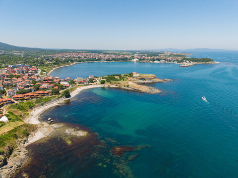 Aerial view of the Vasiliko district in Tsarevo with its charming red-tiled houses, sandy beach, and rocky coastline along the Black Sea in Tsarevo, Burgas, Bulgaria.