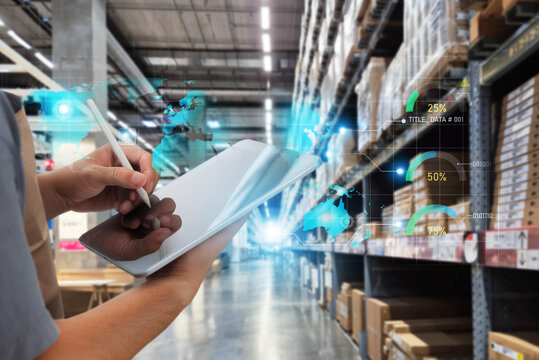 Smart warehouse worker using tablet with global logistics hologram.