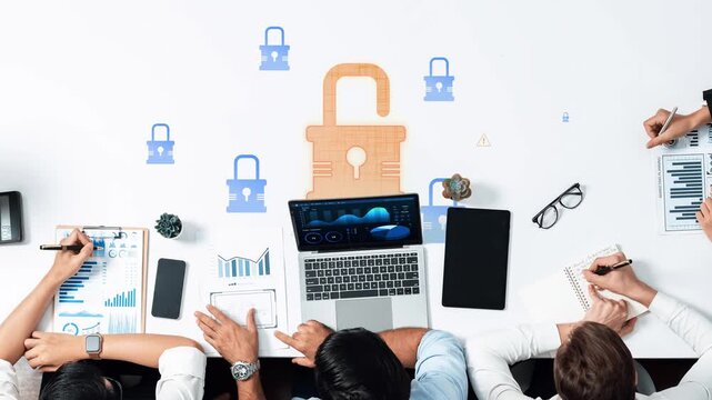 A collaborative workspace showcases a team engaged in planning a data security strategy, featuring charts, a laptop, and a lock icon representing protection measures. Raster