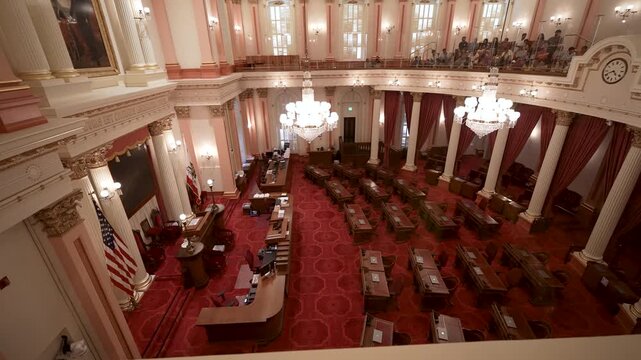 Footage shows the interior of the Senate Chamber in the California State Capitol in Sacramento with empty seats and flags on display