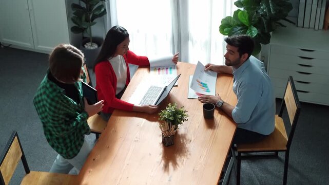 Top view of project manager present financial graph to investors at meeting. Professional marketing team brainstorming financial idea while looking at financial statistic from laptop. Convocation.