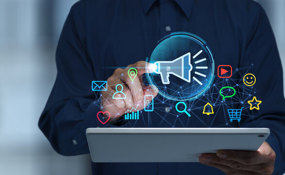 Digital marketing automation technology optimizing campaign performance across social media channels. Analyzing customer data and managing marketing strategies. Businessman tapping tablet.