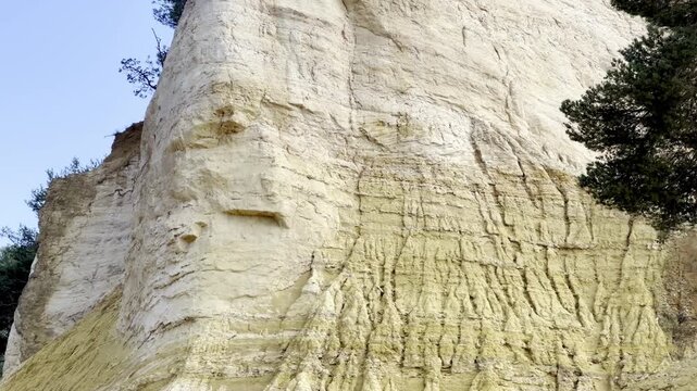 Towering pale white and cream eroded ochre cliff of the Desert Blanc