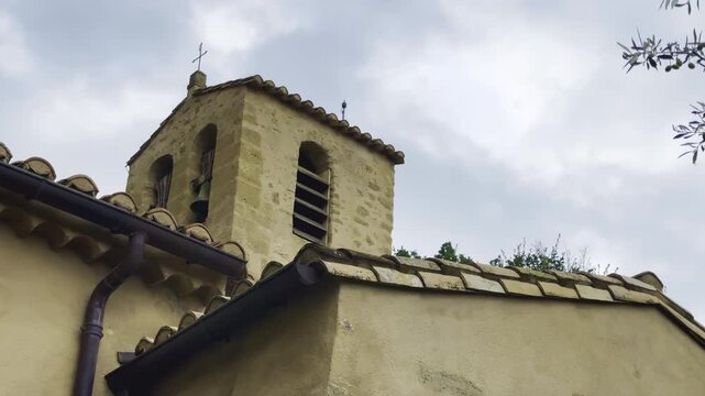 Stone bell tower of the Romanesque church of Saint-Barthelemy