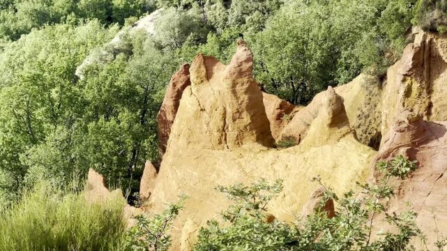 Golden ochre eroded pinnacles and fairy chimneys with rocky capstones