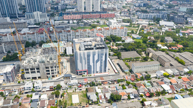 Krung Thep Maha Nakho, Thailand - 21 March 2026: Aerial view of the STT Bangkok 1 data center facility surrounded by ongoing construction, residential housing, and urban infrastructure.