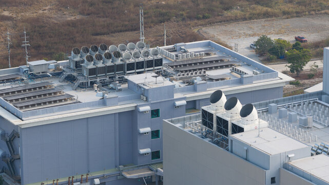 Tambon Don Huaro, Thailand - 11 February 2026: Aerial view of the NTT Global Data Centers Thailand Limited facility featuring large industrial cooling towers and HVAC systems on the rooftop.