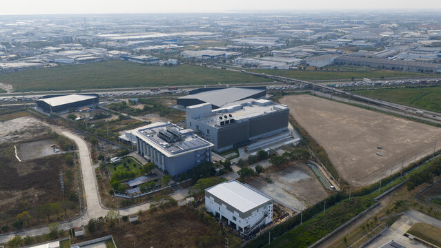 Tambon Don Huaro, Thailand - 11 February 2026: Aerial view of the NTT Global Data Centers Thailand Limited facility featuring large industrial cooling towers and HVAC systems on the rooftop.