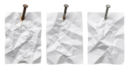 Three crumpled paper sheets with nails on top. © Nad