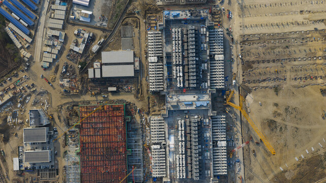 Khlong Tamru, Thailand - 09 March 2026: Aerial view of the Bridge Data Center construction site featuring large industrial structures, cooling units, and heavy machinery.