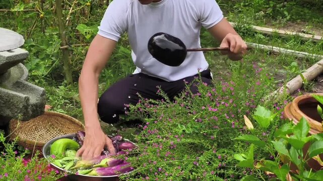 Farmer washing freshly harvested organic vegetables with water in a beautiful garden close up