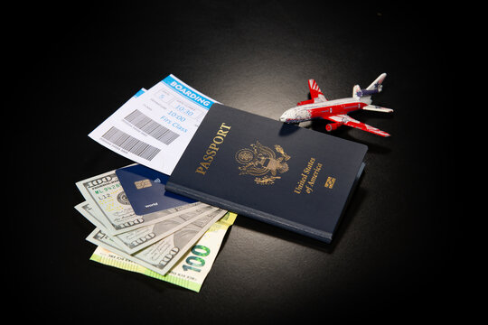 US passport with boarding pass cash and credit card. Travel passport for international trip. American passport and tickets with US dollars for travel preparation. Passport money and for travel.