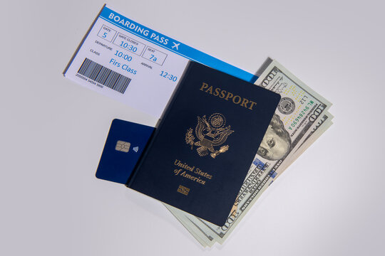 US passport with boarding pass cash and credit card. Travel passport for international trip. American passport and tickets with US dollars for travel preparation. Passport money and for travel.