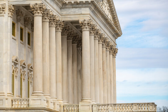 Columns marble facade repetition symmetry. Columns Tall vertical architectural layout. Columns decorative capitals carved ornament. Columns neoclassical heritage exterior.
