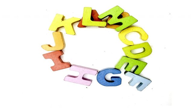 The alphabet makes the letter Q with wooden letters on paper 