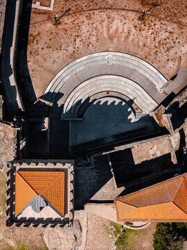 Belmonte, Castilla-La Mancha, Spain - 29 June 2026: Aerial view of Belmonte Castle, featuring its semicircular courtyard with tiered stone seating, terracotta rooftops, and historic stone walls.