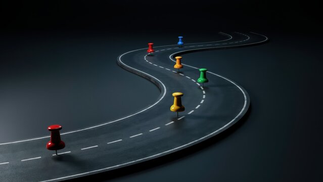 Winding dark asphalt road with colorful pushpins marking a journey or business strategy pathway.