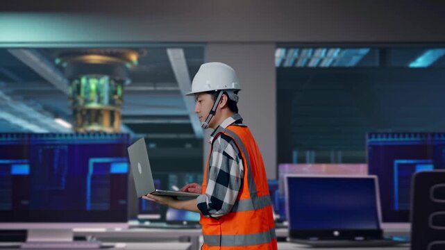 Side View of Asian Male Engineer Use Computer While Walking at Futuristic Quantum Computer Data Center Control Room