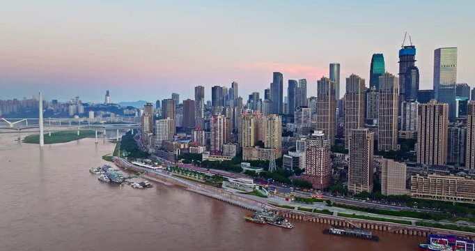 Aerial view of Chongqing city skyline with residential skyscrapers and urban riverfront buildings at sunrise, China