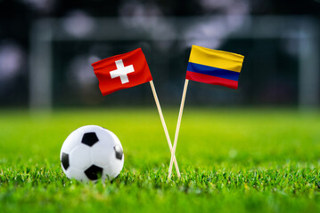 Obraz premium Switzerland vs Colombia, Round of 16, national flags before international football match, football on green grass with stadium in the background, BC Place, Vancouver, Canada, July 7, 2026