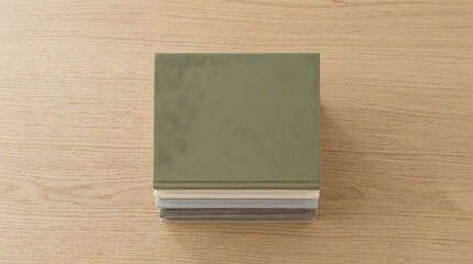 Fototapeta premium Top Down View of Stacked Fabric Cover Books with Hardcover on Wood Table