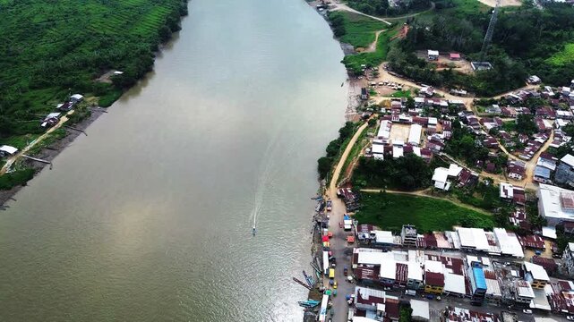 Aerial View of Riverfront Settlement on Amazon River in Ecuador with Boats, Houses, Green Forest and Local Water Transport Scene
