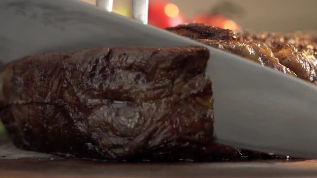 Slicing Juicy Medium Rare Ribeye Steak With Knife.