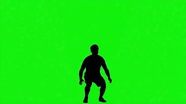 Silhouette Soccer Player Celebrating on Green Screen - A dark silhouette of a soccer player in a celebratory pose stands against a vibrant green screen background.