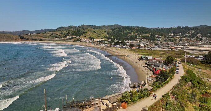 Pacifica California Aerial v8 cinematic low level flyover crescent shaped linda mar state beach capturing surfers catching the waves on a sunny day in the summer - Shot with Mavic 3 Cine - May 2022