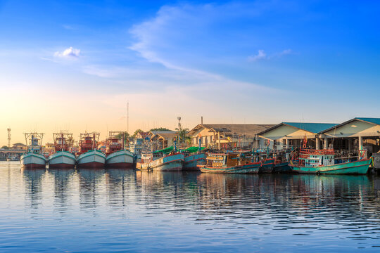 Colorful Fishing Boats Moored at Peaceful Harbor During Sunset