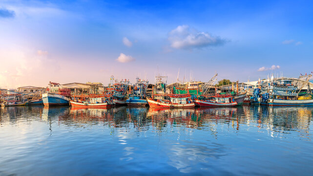 Colorful Wooden Fishing Boats Moored in Calm Harbor Waters