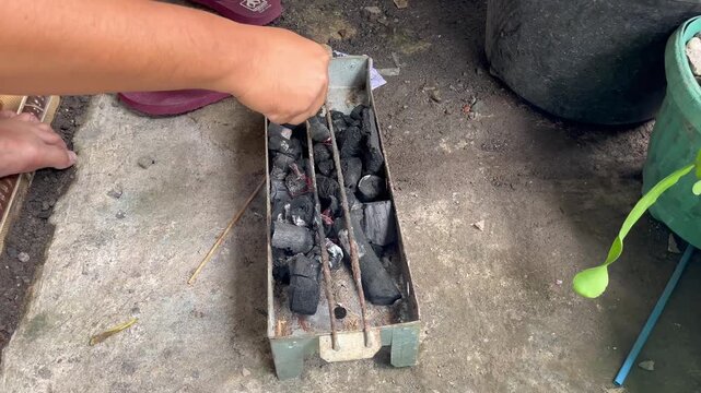 Preparing traditional charcoal grill for outdoor cooking close up