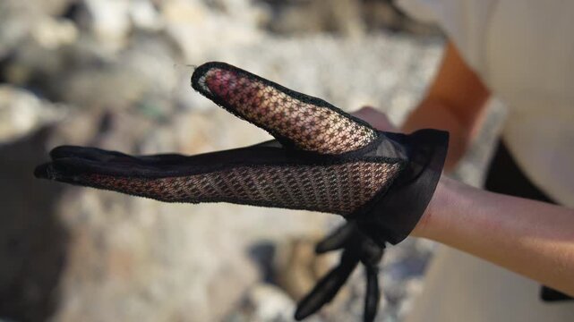 Gloves lace fashion woman putting on elegant black mesh gloves for a vintage inspired look outdoors