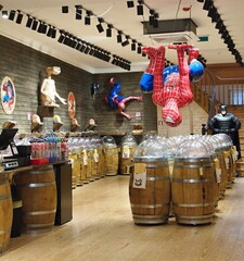 Obraz premium Spider-Man, E.T., Batman figures decorating a candy shop