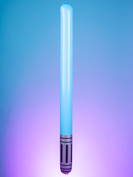 Close-up of an inflatable laser sword toy on a purple background, showcasing its bright colors and futuristic design