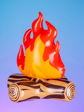 Close-up of an inflatable campfire with logs on a purple background, showcasing its bright colors and playful design